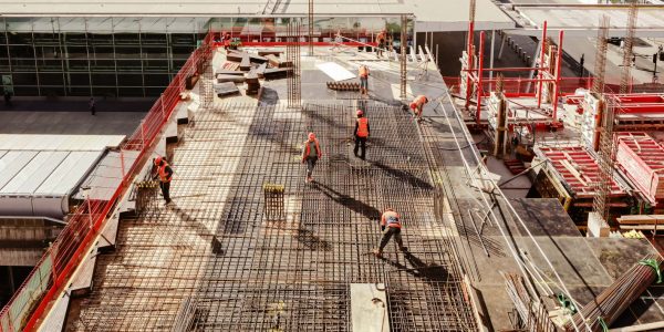 Construction workers at a construction site viewed from above, High angle view of five people with helmets.